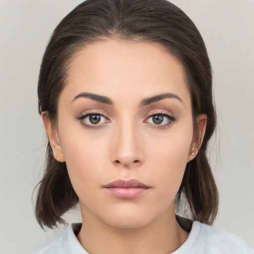 Neutral white young-adult female with medium  brown hair and brown eyes