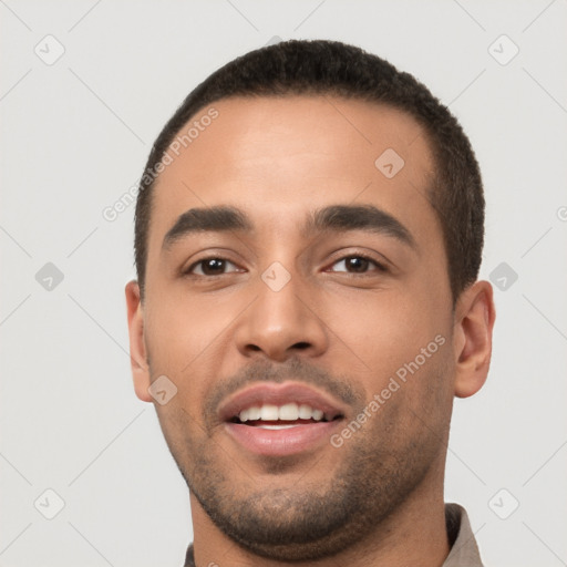 Joyful white young-adult male with short  black hair and brown eyes