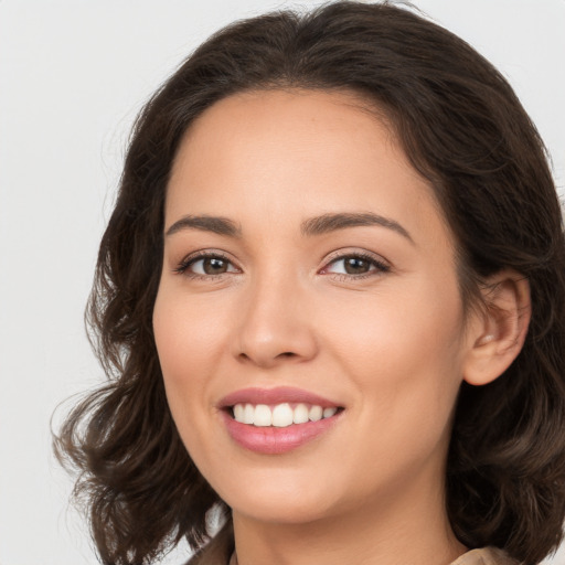 Joyful white young-adult female with long  brown hair and brown eyes