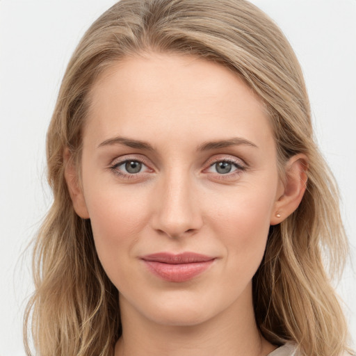 Joyful white young-adult female with long  brown hair and blue eyes