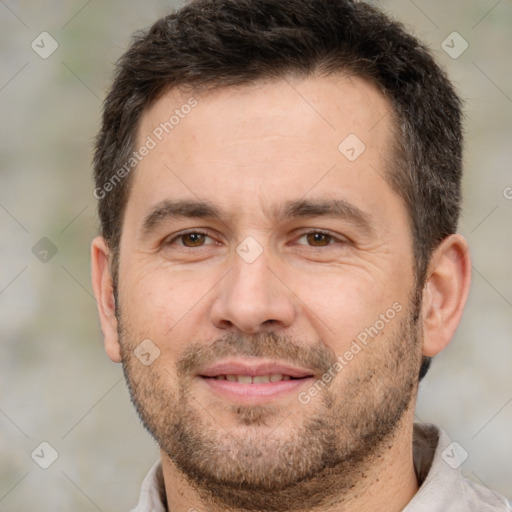 Joyful white adult male with short  brown hair and brown eyes