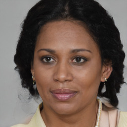 Joyful black adult female with medium  brown hair and brown eyes