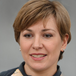 Joyful white adult female with medium  brown hair and grey eyes