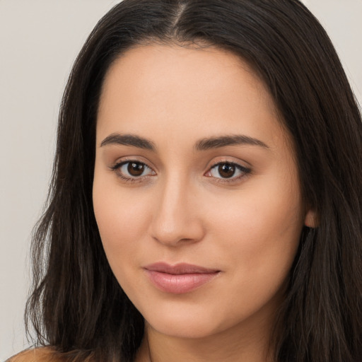 Joyful white young-adult female with long  brown hair and brown eyes