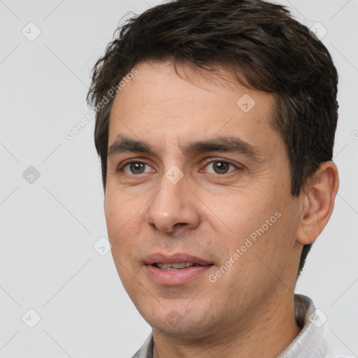 Joyful white adult male with short  brown hair and brown eyes