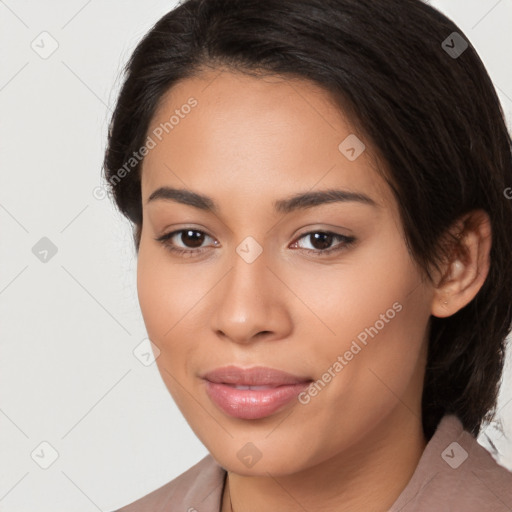 Joyful latino young-adult female with medium  brown hair and brown eyes