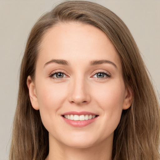 Joyful white young-adult female with long  brown hair and grey eyes