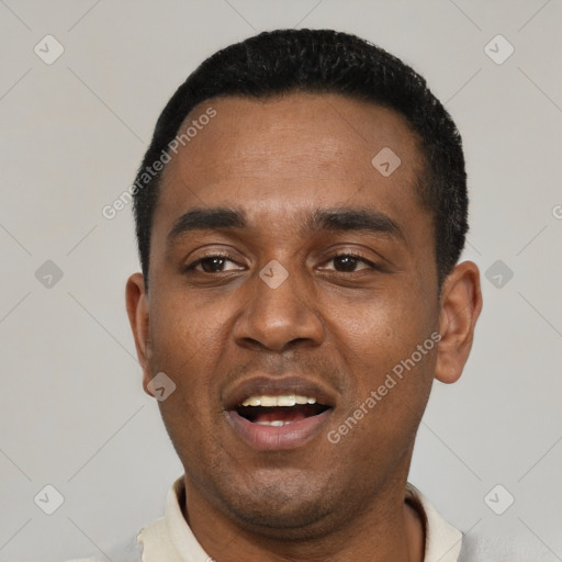 Joyful black young-adult male with short  black hair and brown eyes