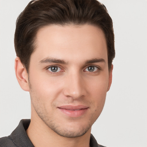 Joyful white young-adult male with short  brown hair and brown eyes