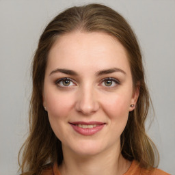 Joyful white young-adult female with long  brown hair and green eyes