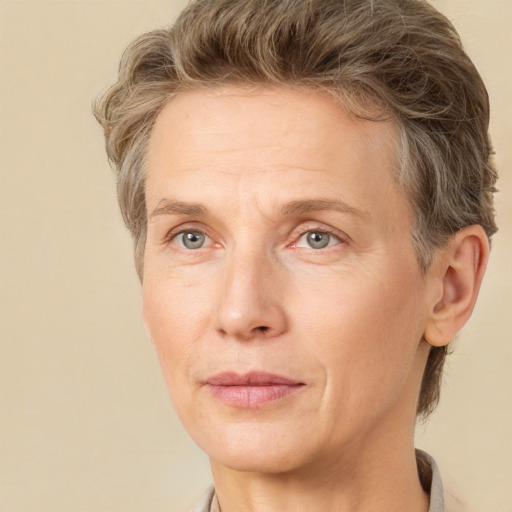 Joyful white adult female with short  brown hair and grey eyes