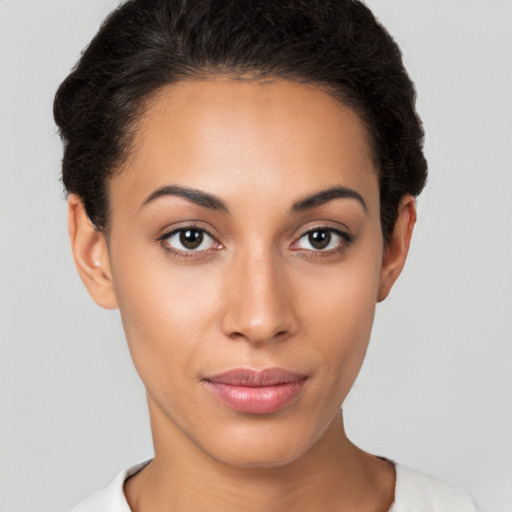 Joyful latino young-adult female with short  brown hair and brown eyes