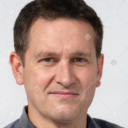 Joyful white adult male with short  brown hair and grey eyes