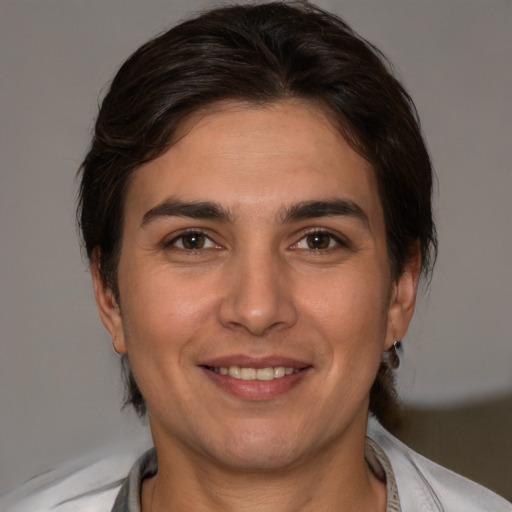 Joyful white young-adult male with medium  brown hair and brown eyes