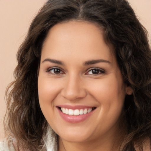 Joyful white young-adult female with long  brown hair and brown eyes