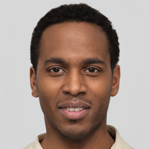 Joyful black young-adult male with short  black hair and brown eyes