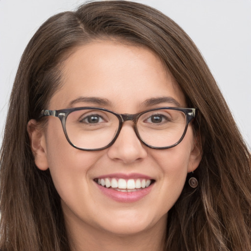 Joyful white young-adult female with long  brown hair and grey eyes