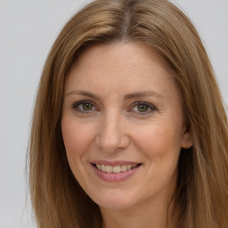 Joyful white adult female with long  brown hair and brown eyes