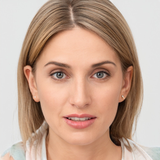 Joyful white young-adult female with medium  brown hair and grey eyes