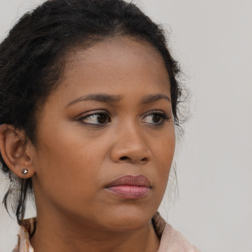 Neutral black young-adult female with long  brown hair and brown eyes