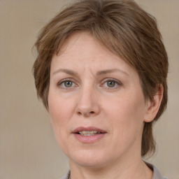 Joyful white adult female with medium  brown hair and grey eyes