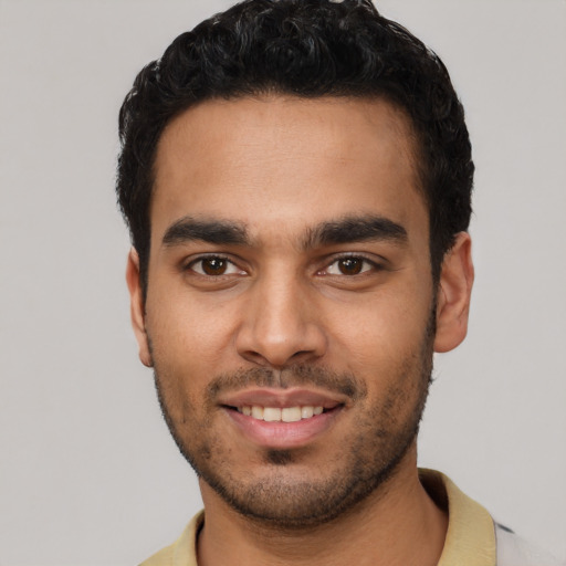 Joyful latino young-adult male with short  black hair and brown eyes