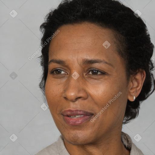 Joyful black adult female with short  brown hair and brown eyes