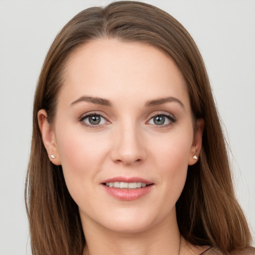 Joyful white young-adult female with long  brown hair and grey eyes