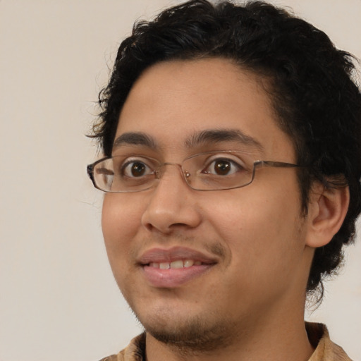 Joyful latino young-adult male with short  brown hair and brown eyes