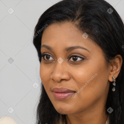 Joyful latino young-adult female with long  black hair and brown eyes