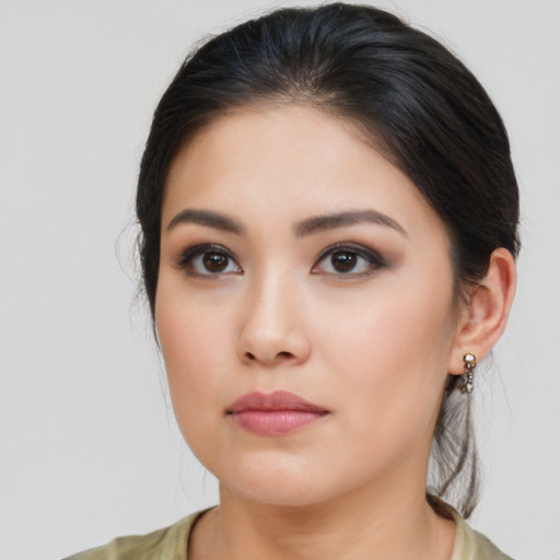 Joyful asian young-adult female with long  brown hair and brown eyes