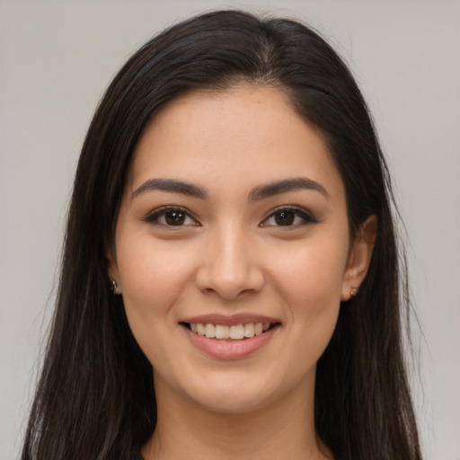 Joyful latino young-adult female with long  brown hair and brown eyes