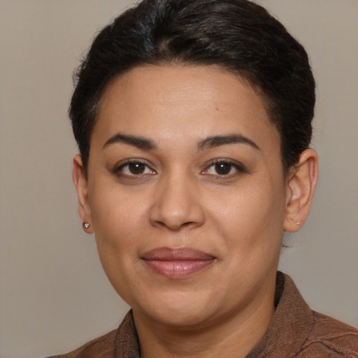 Joyful latino adult female with short  brown hair and brown eyes
