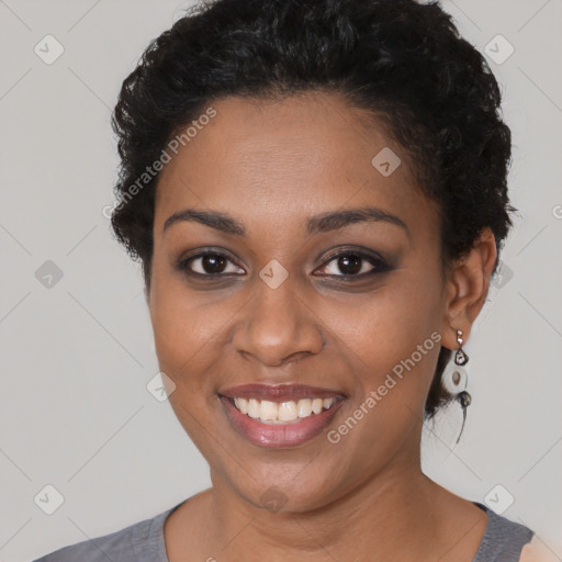 Joyful black young-adult female with short  black hair and brown eyes