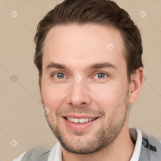 Joyful white young-adult male with short  brown hair and grey eyes