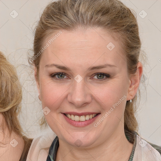 Joyful white young-adult female with medium  brown hair and blue eyes