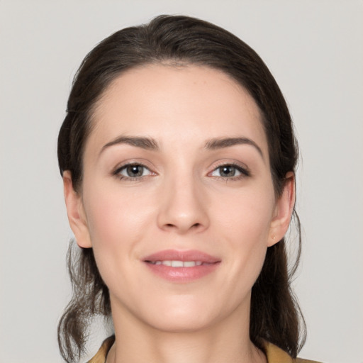 Joyful white young-adult female with medium  brown hair and brown eyes