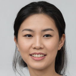 Joyful asian young-adult female with medium  brown hair and brown eyes