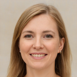 Joyful white young-adult female with long  brown hair and brown eyes