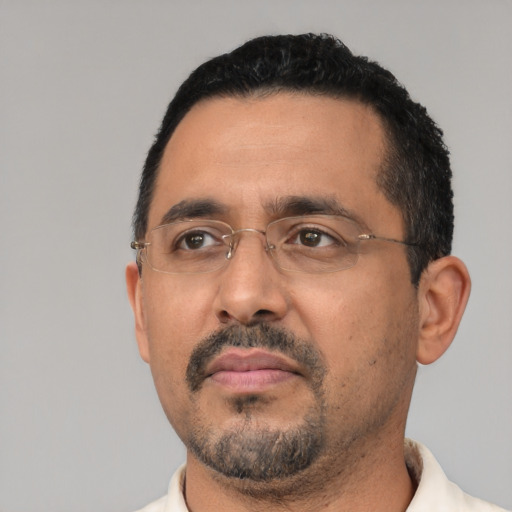 Neutral latino adult male with short  black hair and brown eyes