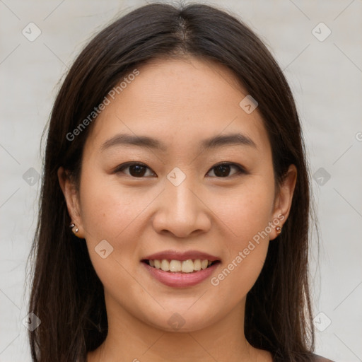 Joyful asian young-adult female with long  brown hair and brown eyes