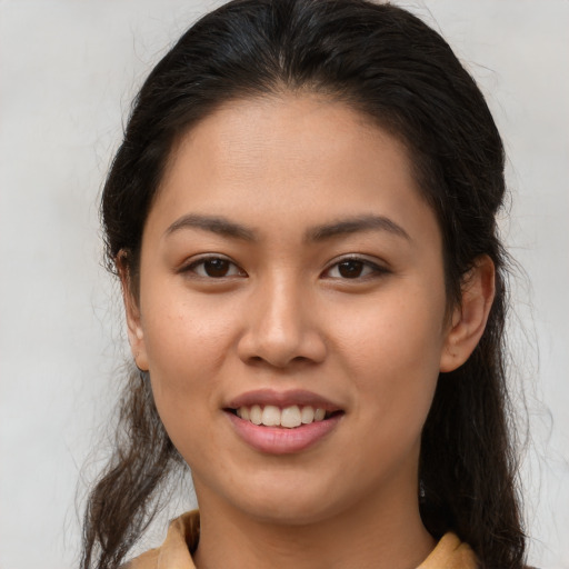 Joyful asian young-adult female with long  brown hair and brown eyes