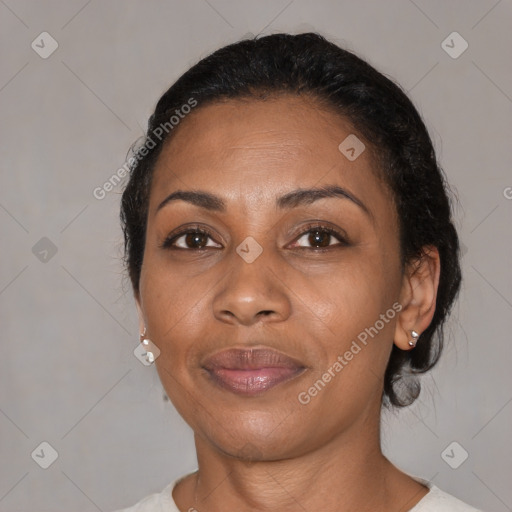 Joyful black adult female with medium  brown hair and brown eyes