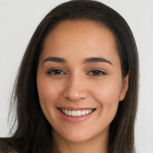 Joyful white young-adult female with long  brown hair and brown eyes