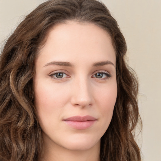 Joyful white young-adult female with long  brown hair and green eyes