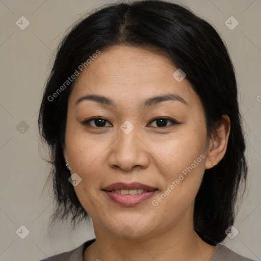 Joyful asian adult female with medium  brown hair and brown eyes