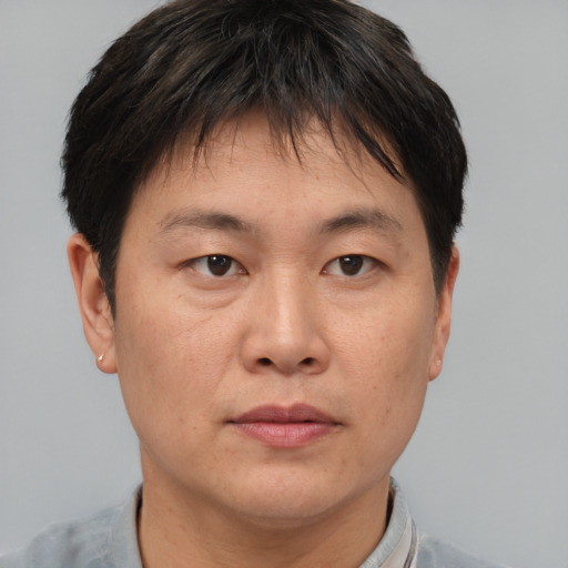 Neutral asian adult male with short  brown hair and brown eyes