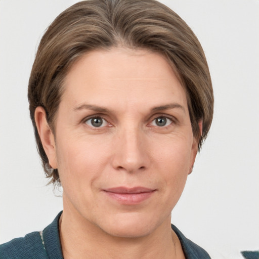 Joyful white adult female with medium  brown hair and grey eyes