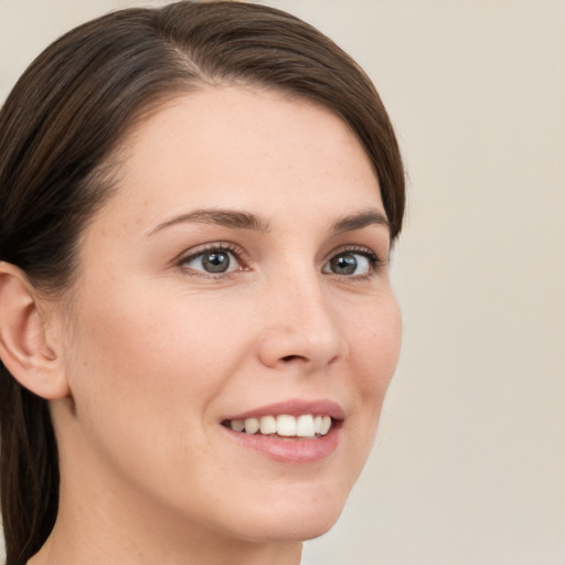 Joyful white young-adult female with medium  brown hair and brown eyes