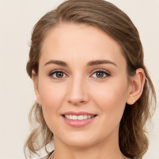 Joyful white young-adult female with medium  brown hair and grey eyes